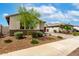 Well-maintained front yard with desert landscaping and a glimpse of a cozy home at 13228 W Buckskin Trl, Peoria, AZ 85383