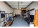 Spacious garage featuring durable epoxy flooring, ample storage, and a variety of tools and equipment at 13228 W Buckskin Trl, Peoria, AZ 85383
