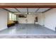 Open garage with epoxy flooring, overhead storage racks, and a clean, organized layout at 13228 W Buckskin Trl, Peoria, AZ 85383