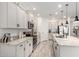 Modern kitchen featuring white cabinetry, stainless steel appliances, and a large island with pendant lighting at 13228 W Buckskin Trl, Peoria, AZ 85383