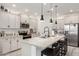 Bright kitchen with white cabinetry, granite countertops, stainless steel appliances, and a large island at 13228 W Buckskin Trl, Peoria, AZ 85383