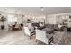 Open-concept living space with a sectional sofa, dining area, and a bright kitchen with white cabinetry at 13228 W Buckskin Trl, Peoria, AZ 85383