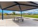 Covered park pavilion with picnic tables, nearby playground, and well-maintained green space at 13228 W Buckskin Trl, Peoria, AZ 85383