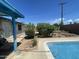 Enjoy this backyard pool surrounded by mature trees and a partially completed fire pit area at 1529 W Eva St, Phoenix, AZ 85021
