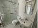 Well-lit bathroom with a glass shower, classic sink, and a bright mirror at 1529 W Eva St, Phoenix, AZ 85021