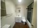 Cozy bathroom with a white vanity and cabinet storage, along with a tiled shower and toilet at 1529 W Eva St, Phoenix, AZ 85021