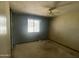 View of a bedroom with a ceiling fan and window; needs updating at 1529 W Eva St, Phoenix, AZ 85021