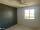 Bedroom featuring a ceiling fan, window letting in natural light, and painted accent wall at 1529 W Eva St, Phoenix, AZ 85021