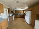 Bright kitchen featuring wood cabinetry, stainless steel appliances, and tiled flooring at 1529 W Eva St, Phoenix, AZ 85021