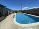Backyard in-ground pool with refreshing blue water, surrounded by a concrete deck and block wall at 1529 W Eva St, Phoenix, AZ 85021