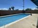 Backyard in-ground pool with refreshing blue water, surrounded by a concrete deck and block wall at 1529 W Eva St, Phoenix, AZ 85021