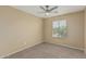 A bedroom featuring neutral walls, a ceiling fan, and a window with blinds at 15420 W Canterbury Dr, Surprise, AZ 85379