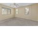 Spacious bedroom featuring neutral tones, carpeting, ceiling fan and lots of light at 15420 W Canterbury Dr, Surprise, AZ 85379