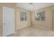 Bright dining area featuring tile floors, a modern chandelier, and natural lighting at 15420 W Canterbury Dr, Surprise, AZ 85379