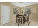 Cozy dining area featuring a chandelier and natural light, adjacent to a tiled room at 15420 W Canterbury Dr, Surprise, AZ 85379