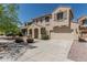 Beautiful two-story home featuring a tile roof, two-car garage, and inviting entryway at 15420 W Canterbury Dr, Surprise, AZ 85379