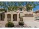 Attractive two-story home showcasing a well-maintained front yard and attached two-car garage at 15420 W Canterbury Dr, Surprise, AZ 85379