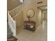 Inviting foyer with stairs, a mirror, and console table, creating an elegant entryway at 15420 W Canterbury Dr, Surprise, AZ 85379