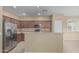 Bright kitchen features stainless steel appliances, laminate counters, and breakfast bar at 15420 W Canterbury Dr, Surprise, AZ 85379