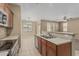 Kitchen offering stainless steel appliances, wood cabinets, and a breakfast bar for extra seating at 15420 W Canterbury Dr, Surprise, AZ 85379