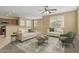 Open-concept living room filled with natural light and neutral furnishings and decor at 15420 W Canterbury Dr, Surprise, AZ 85379