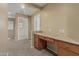 Office with a built-in desk and drawers, carpeted floor and two entry doors at 15420 W Canterbury Dr, Surprise, AZ 85379