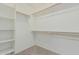 Spacious walk-in closet with multiple shelves and ample hanging space for organized storage at 15420 W Canterbury Dr, Surprise, AZ 85379