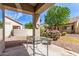 Inviting covered back patio with seating area and view of the landscaped backyard at 1577 E Earl Dr, Casa Grande, AZ 85122