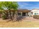 Charming backyard featuring mature landscaping and desertscape with convenient covered patio at 1577 E Earl Dr, Casa Grande, AZ 85122