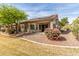 Scenic backyard features drought resistant desert landscaping with private covered patio at 1577 E Earl Dr, Casa Grande, AZ 85122