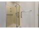 A clean bathroom featuring a glass enclosed shower with a built-in seat and grab bars at 1577 E Earl Dr, Casa Grande, AZ 85122