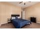 A well lit bedroom featuring a ceiling fan and modern decor at 1577 E Earl Dr, Casa Grande, AZ 85122