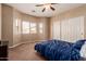 Carpeted bedroom with ceiling fan and window overlooking front yard at 1577 E Earl Dr, Casa Grande, AZ 85122