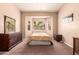 Cozy bedroom featuring neutral tones, carpet flooring, and a large window for natural light at 1577 E Earl Dr, Casa Grande, AZ 85122