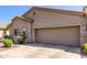 Exterior view of home with two-car garage, desert landscaping, and covered entry at 1577 E Earl Dr, Casa Grande, AZ 85122