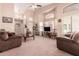 Bright living room with high ceilings, large windows, and neutral carpeting at 1577 E Earl Dr, Casa Grande, AZ 85122