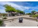 View of backyard with desert landscaping and a fire pit at 15976 W La Paloma Dr, Surprise, AZ 85374
