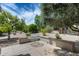 A lovely backyard with desert landscaping and mature trees, offering a serene outdoor space at 15976 W La Paloma Dr, Surprise, AZ 85374