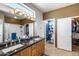 Bathroom showcasing double sinks with granite countertops and private toilet room at 15976 W La Paloma Dr, Surprise, AZ 85374