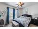 Comfortable bedroom featuring a large bed with bright patterned bedding and natural light at 15976 W La Paloma Dr, Surprise, AZ 85374