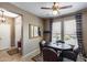 Cozy dining area with wood table, seating for six, and natural light from windows at 15976 W La Paloma Dr, Surprise, AZ 85374