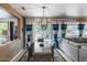 Open-concept dining area with modern chandelier and sliding glass doors to the backyard patio at 15976 W La Paloma Dr, Surprise, AZ 85374