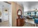 Open-concept entryway featuring a wood dresser with mirror, flowing into the living room at 15976 W La Paloma Dr, Surprise, AZ 85374