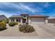 Charming single-story home featuring a red tile roof, two-car garage, and low-maintenance desert landscaping at 15976 W La Paloma Dr, Surprise, AZ 85374