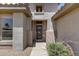 Inviting front entrance with security door, decorative niche, and desert plants at 15976 W La Paloma Dr, Surprise, AZ 85374