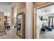 Inviting hallway featuring tile floors, decorative mirror, and seamless flow into the living spaces at 15976 W La Paloma Dr, Surprise, AZ 85374