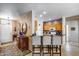Kitchen view from breakfast bar featuring granite countertops, wooden cabinets, and stainless steel appliances at 15976 W La Paloma Dr, Surprise, AZ 85374