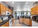 Spacious kitchen featuring wooden cabinetry, granite countertops, and modern appliances at 15976 W La Paloma Dr, Surprise, AZ 85374