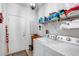 Functional laundry room featuring a white washer and dryer and ample storage space at 15976 W La Paloma Dr, Surprise, AZ 85374