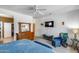 Spacious primary bedroom showcasing a ceiling fan, walk-in closet and a relaxing seating area at 15976 W La Paloma Dr, Surprise, AZ 85374